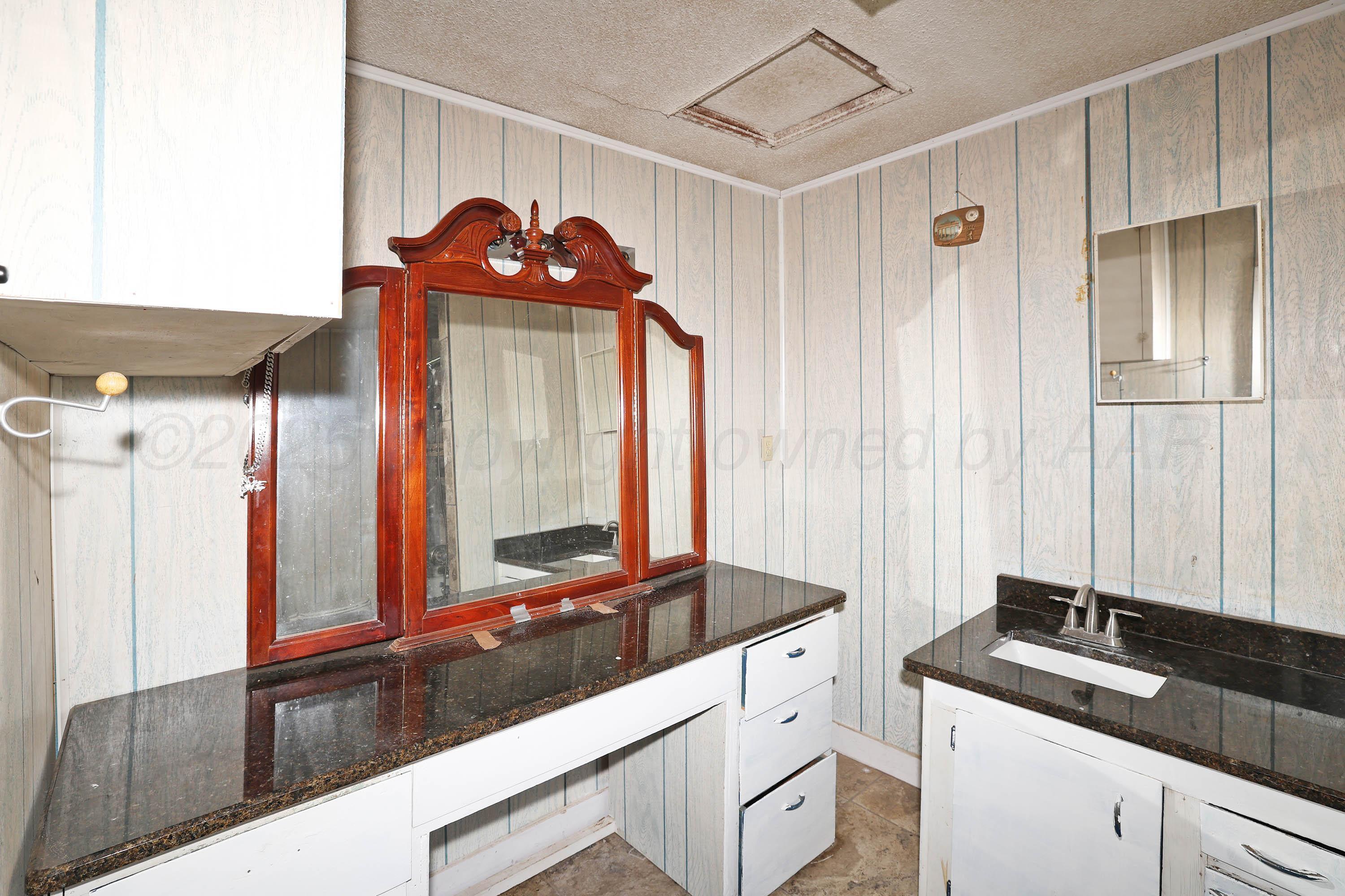 2001 Northwest 13th Avenue Amarillo, TX 79107 - Photo 15 of 35 a bathroom with a sink and a mirror