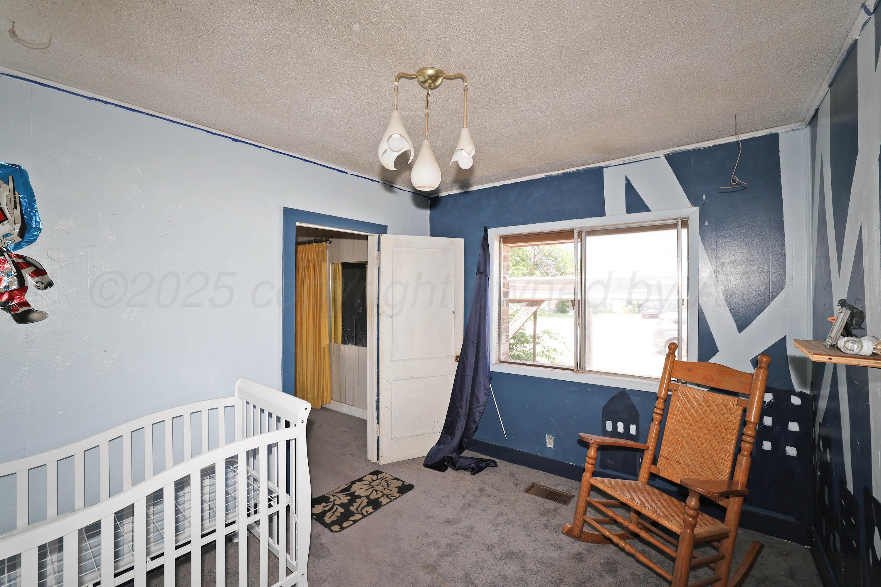 2001 Northwest 13th Avenue Amarillo, TX 79107 - Photo 17 of 35 a living room with furniture a window and a chandelier