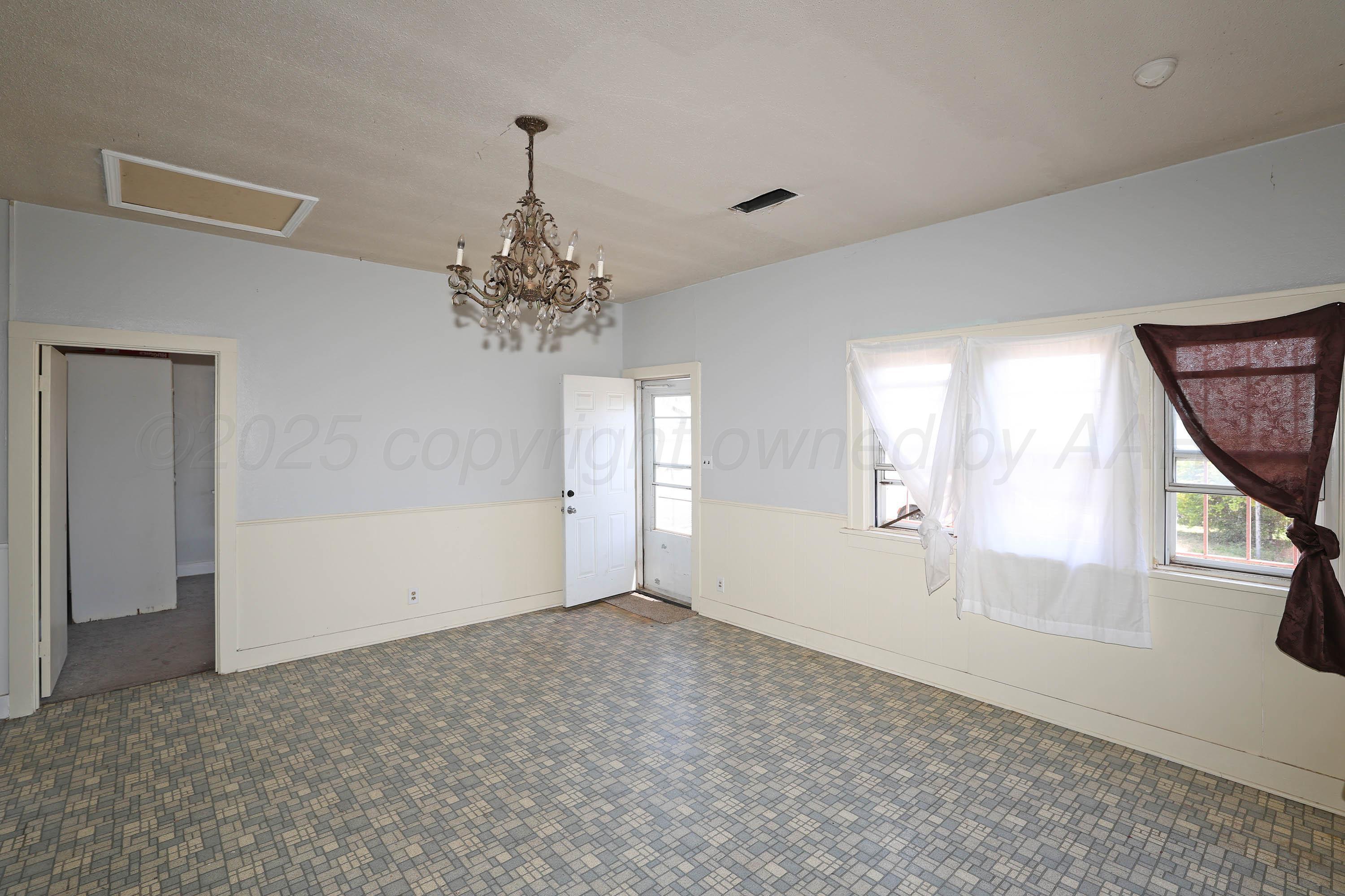 2001 Northwest 13th Avenue Amarillo, TX 79107 - Photo 7 of 35 wooden floor in an empty room with a window