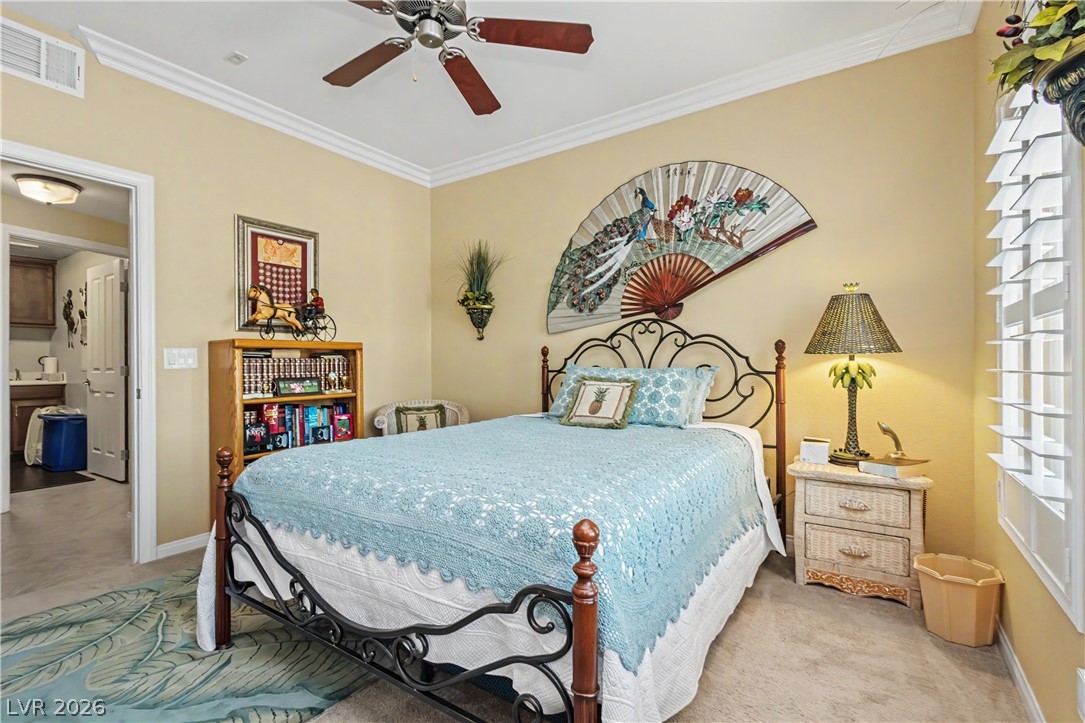 2555 Hampton Road, Unit 3308 Henderson, NV 89052 - Photo 33 of 65 Well-lit sleeping quarters featuring crown molding and a ceiling fan for comfort.