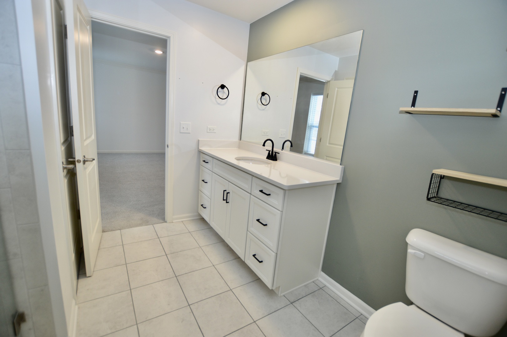 1029 Draper Road McHenry, IL 60050 - Photo 15 of 26 a spacious bathroom with a double vanity sink toilet and mirror