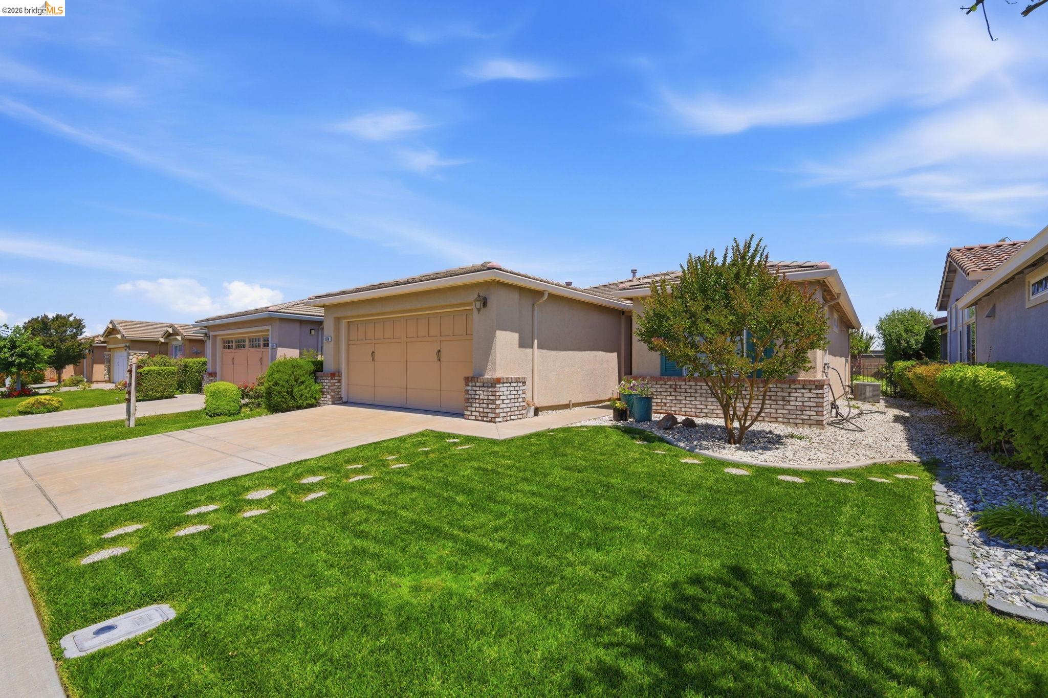 1024 Diamante Rio Vista, CA 94571 - Photo 2 of 27 Stucco exterior with brick detailing and a two-car garage