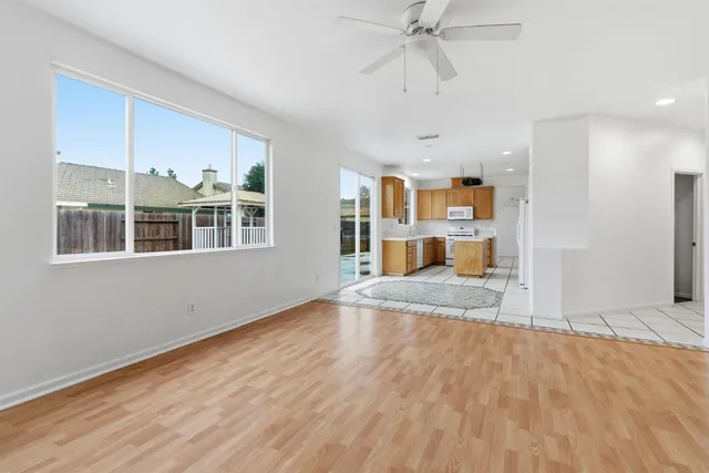 a view of an empty room with a fireplace and a window