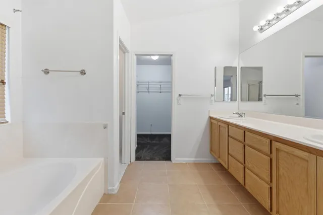 a spacious bathroom with a double vanity sink mirror and double