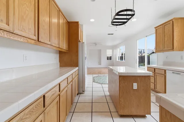 a kitchen with stainless steel appliances a sink a stove and a refrigerator
