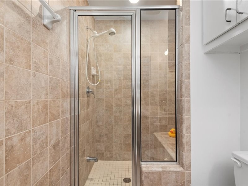 5941 South Loop E Freeway, Unit 504 Houston, TX 77033 - Photo 14 of 39 a bathroom with a glass shower door