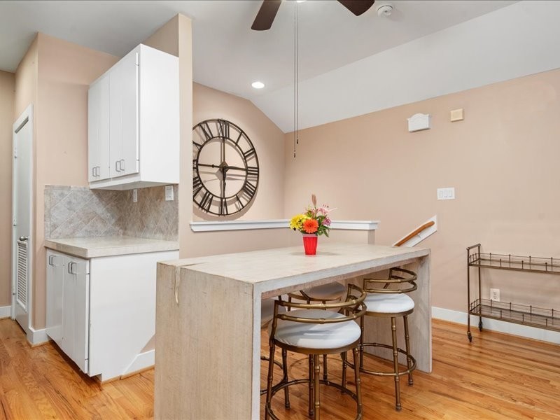 5941 South Loop E Freeway, Unit 504 Houston, TX 77033 - Photo 21 of 39 a kitchen with stainless steel appliances granite countertop a sink a stove a dining table and chairs with wooden floor