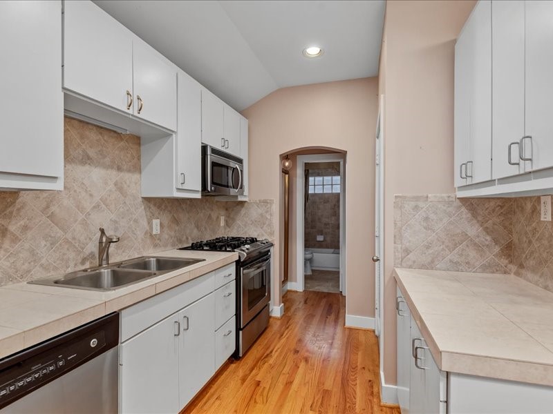 5941 South Loop E Freeway, Unit 504 Houston, TX 77033 - Photo 22 of 39 a kitchen with a sink stove and refrigerator