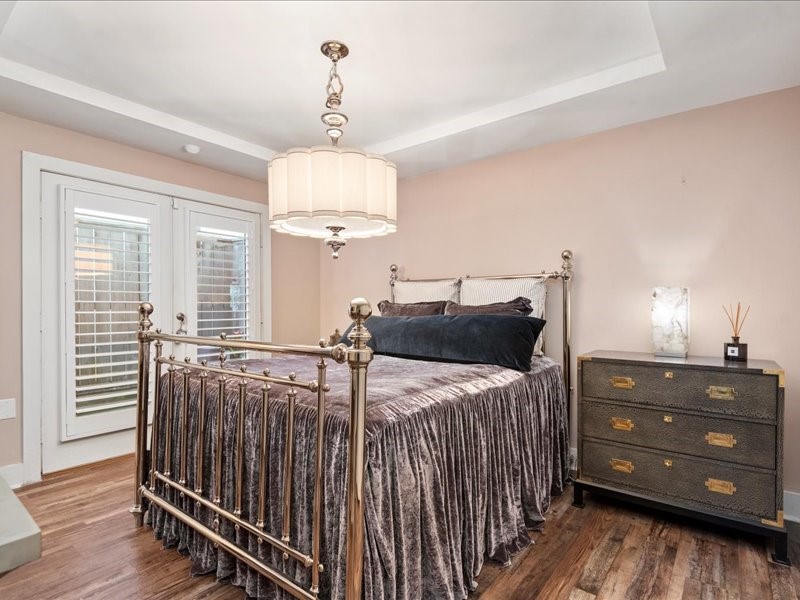 5941 South Loop E Freeway, Unit 504 Houston, TX 77033 - Photo 9 of 39 a bedroom with a bed and a chandelier