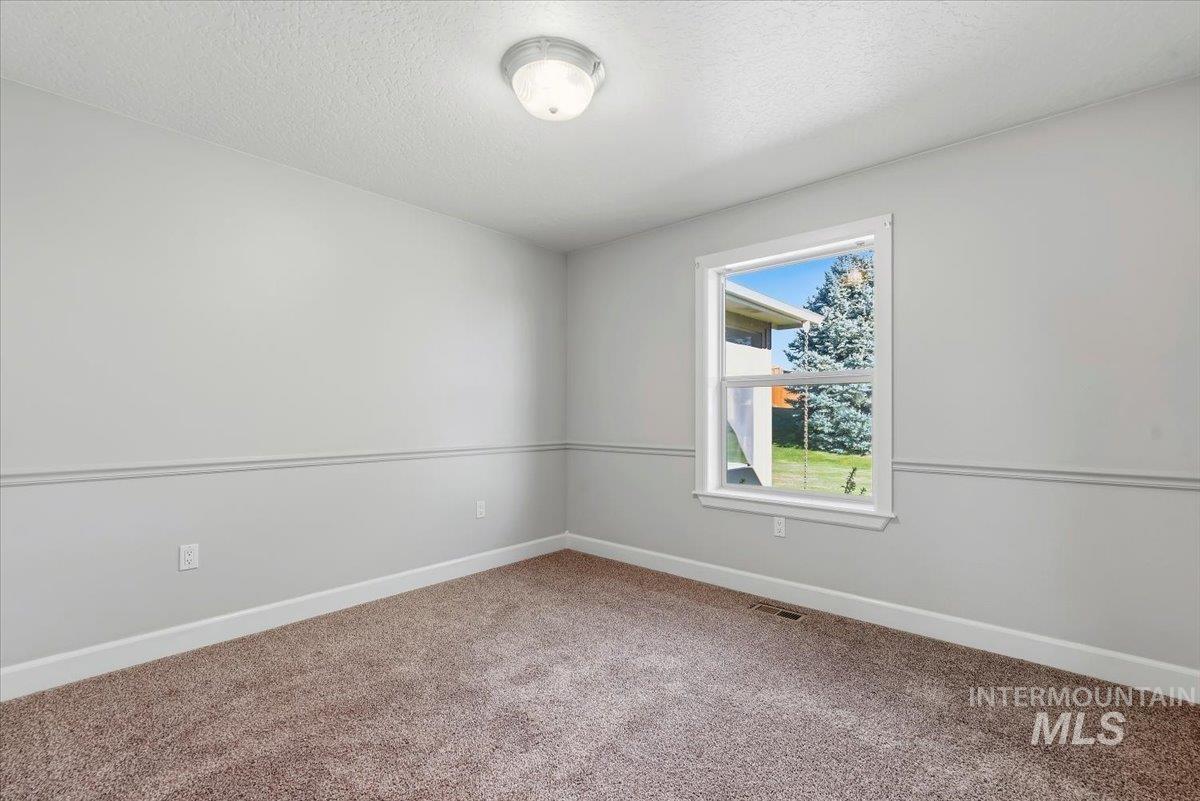 24240 Tiger Lane Caldwell, ID 83607 - Photo 24 of 50 Neutral wall paint with chair rail detailing