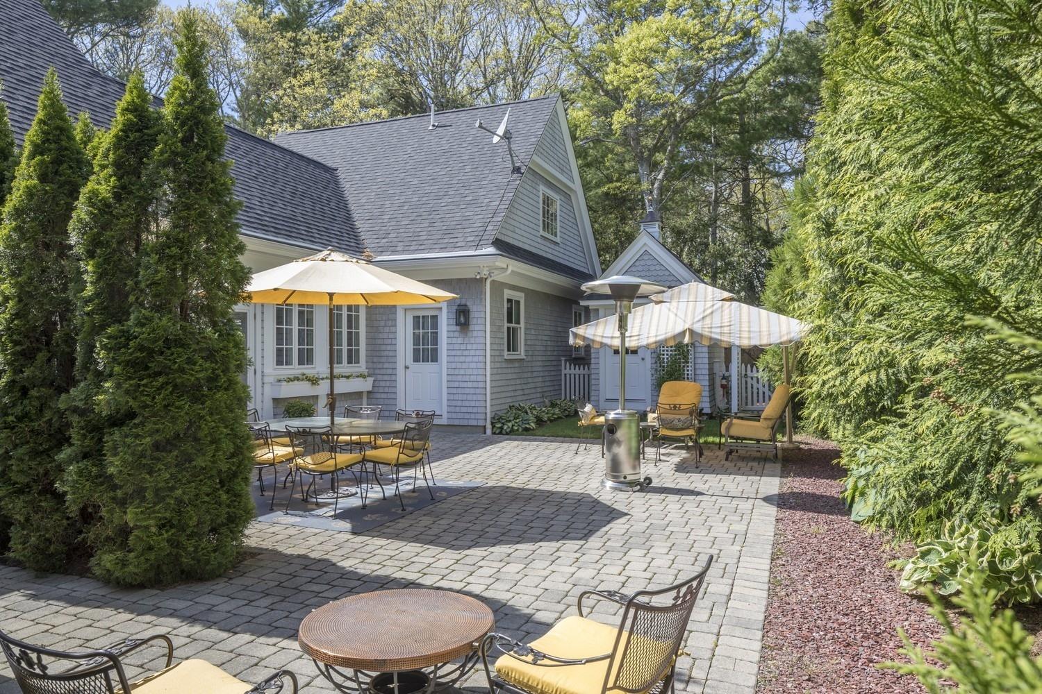 30 Barnard Road Osterville, MA 02655 - Photo 4 of 18 a patio with a table and chairs under an umbrella