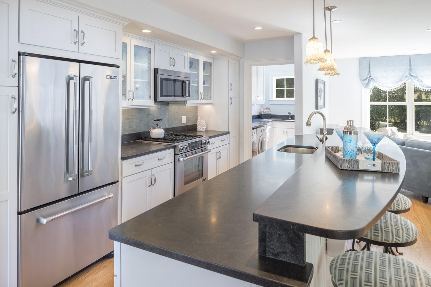 30 Barnard Road Osterville, MA 02655 - Photo 6 of 18 a kitchen with stainless steel appliances granite countertop a sink a stove a refrigerator cabinets and chairs
