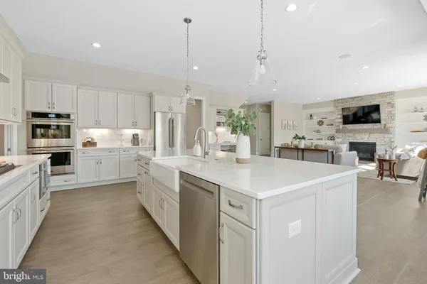 a large kitchen with stainless steel appliances kitchen island granite countertop a large island in the center