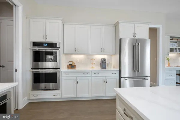 a kitchen with cabinets stainless steel appliances and a window