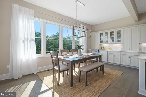 a view of a dining room with furniture window and wooden floor