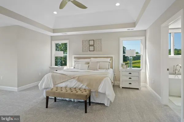 a spacious bathroom with double sink and a mirror