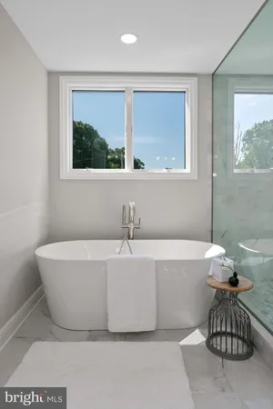 a bathroom with a granite countertop sink toilet and a mirror