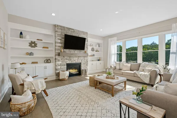 a living room with furniture fireplace and a flat screen tv