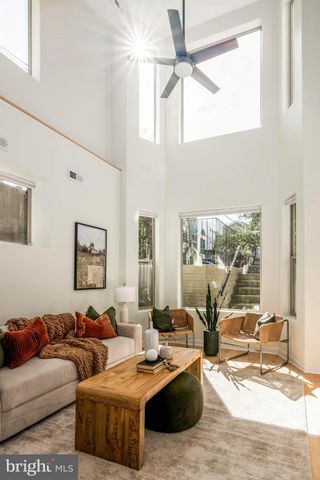 a living room with lots of furniture and a wooden floor