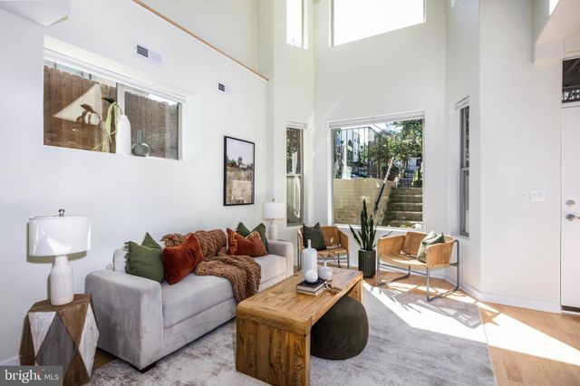 a dining room with wooden floor a glass table and chairs