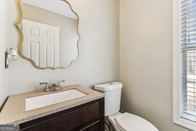 a view of backyard with outdoor seating and trees