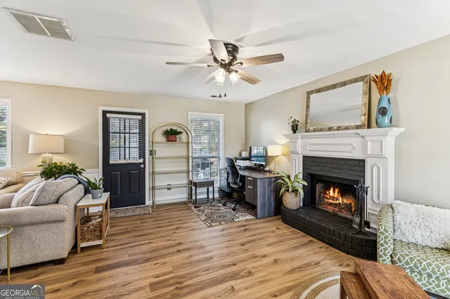 a living room with furniture and a fireplace