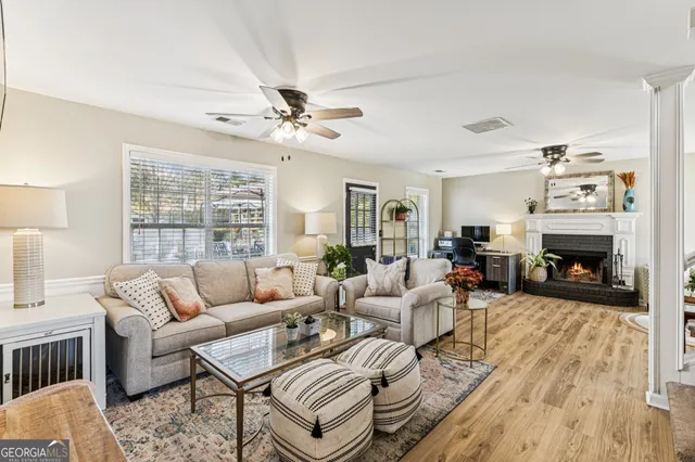 a living room with furniture a fireplace and a table