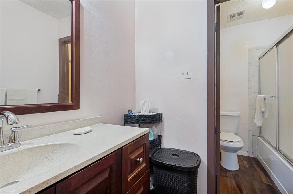 5981 Arapaho Road, Unit 309 Dallas, TX 75248 - Photo 12 of 13 a bathroom with a sink and a toilet
