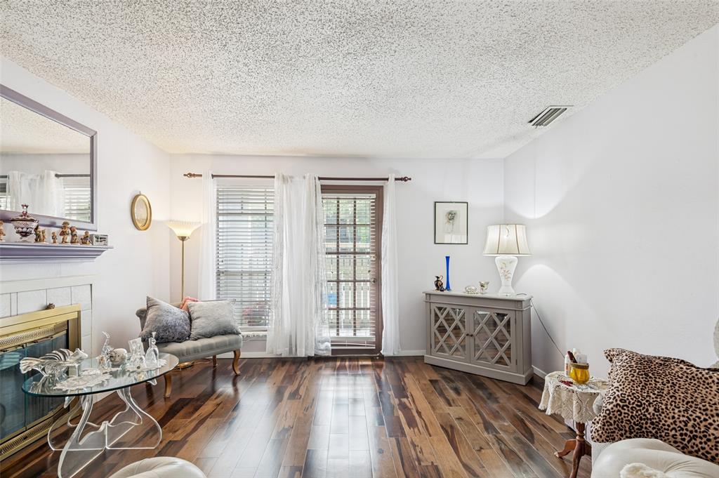 5981 Arapaho Road, Unit 309 Dallas, TX 75248 - Photo 4 of 13 a living room with furniture and wooden floor