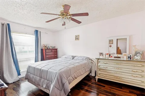 a bedroom with a bed and a large mirror