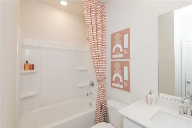 a bathroom with a bathtub and shower