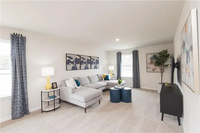 a living room with furniture wooden floor and a large window