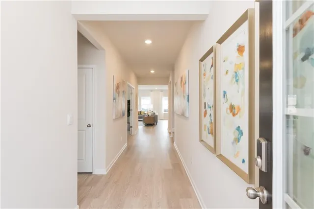 a view of a hallway with wooden floor and staircase