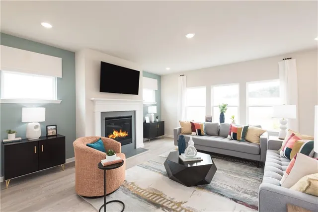 a living room with furniture a fireplace and a flat screen tv