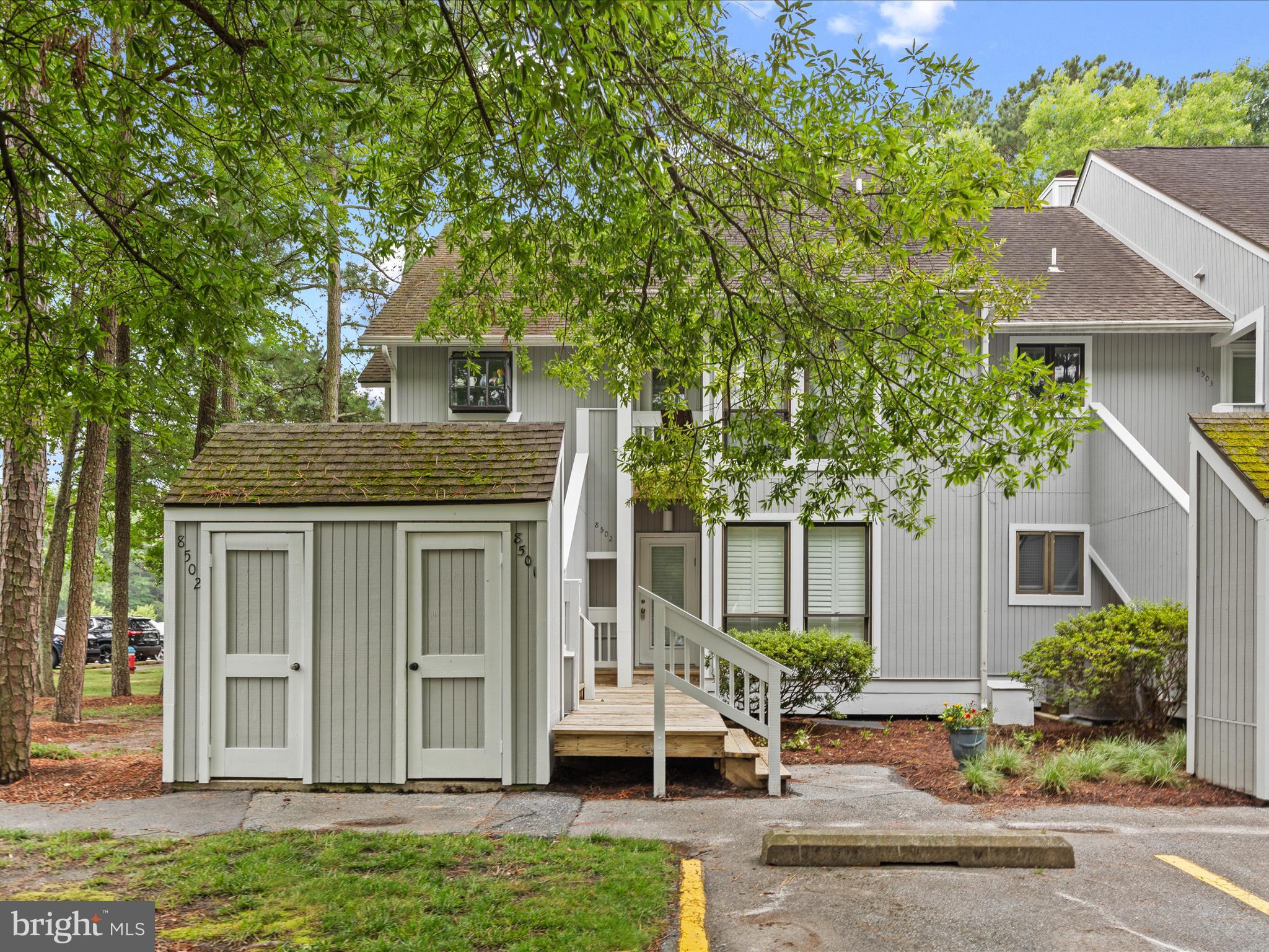 39346 Racquet Lane, Unit 8502 Bethany Beach, DE 19930 - Photo 1 of 33 a front view of a house with garden