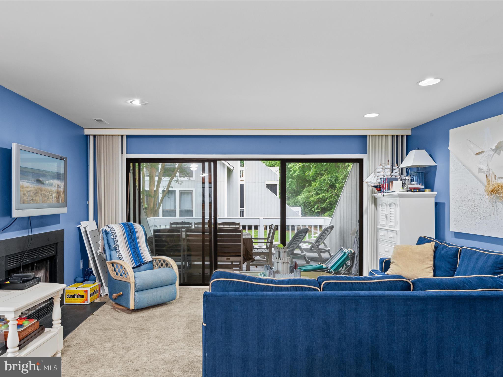 39346 Racquet Lane, Unit 8502 Bethany Beach, DE 19930 - Photo 11 of 33 a living room with furniture a flat screen tv and a large window