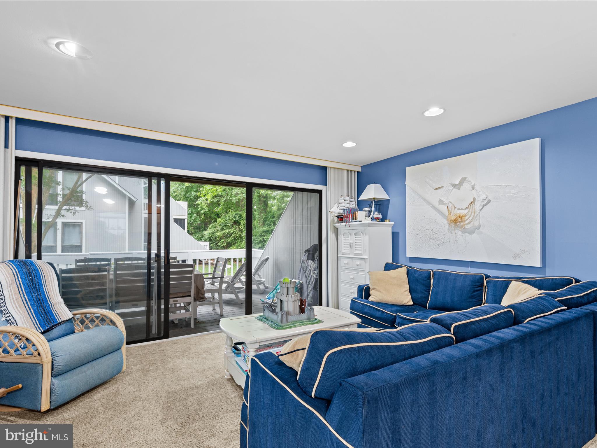 39346 Racquet Lane, Unit 8502 Bethany Beach, DE 19930 - Photo 12 of 33 a living room with furniture and a large window