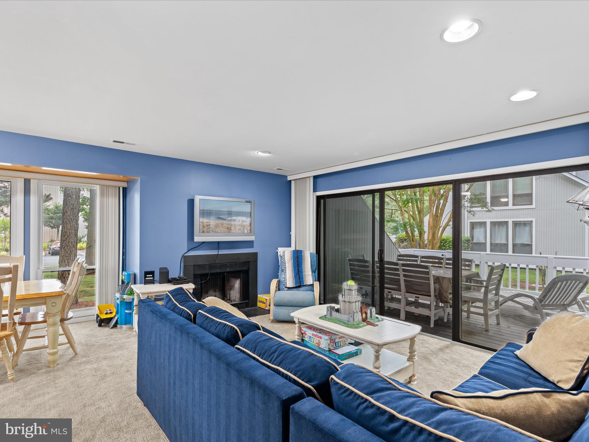 39346 Racquet Lane, Unit 8502 Bethany Beach, DE 19930 - Photo 13 of 33 a living room with furniture a fireplace and a floor to ceiling window