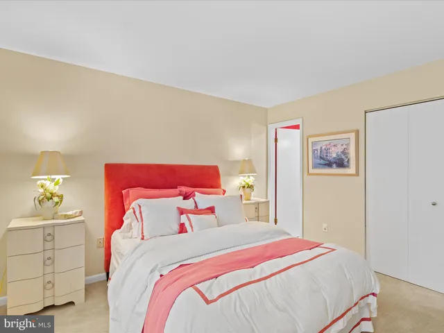 a bedroom with a bed and painting on the wall