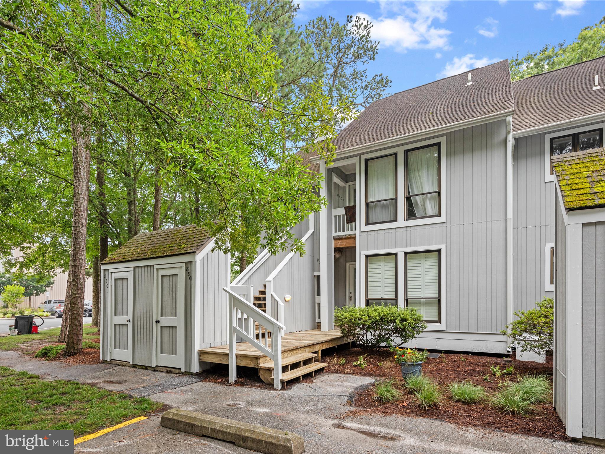 39346 Racquet Lane, Unit 8502 Bethany Beach, DE 19930 - Photo 2 of 33 a front view of a house with a yard