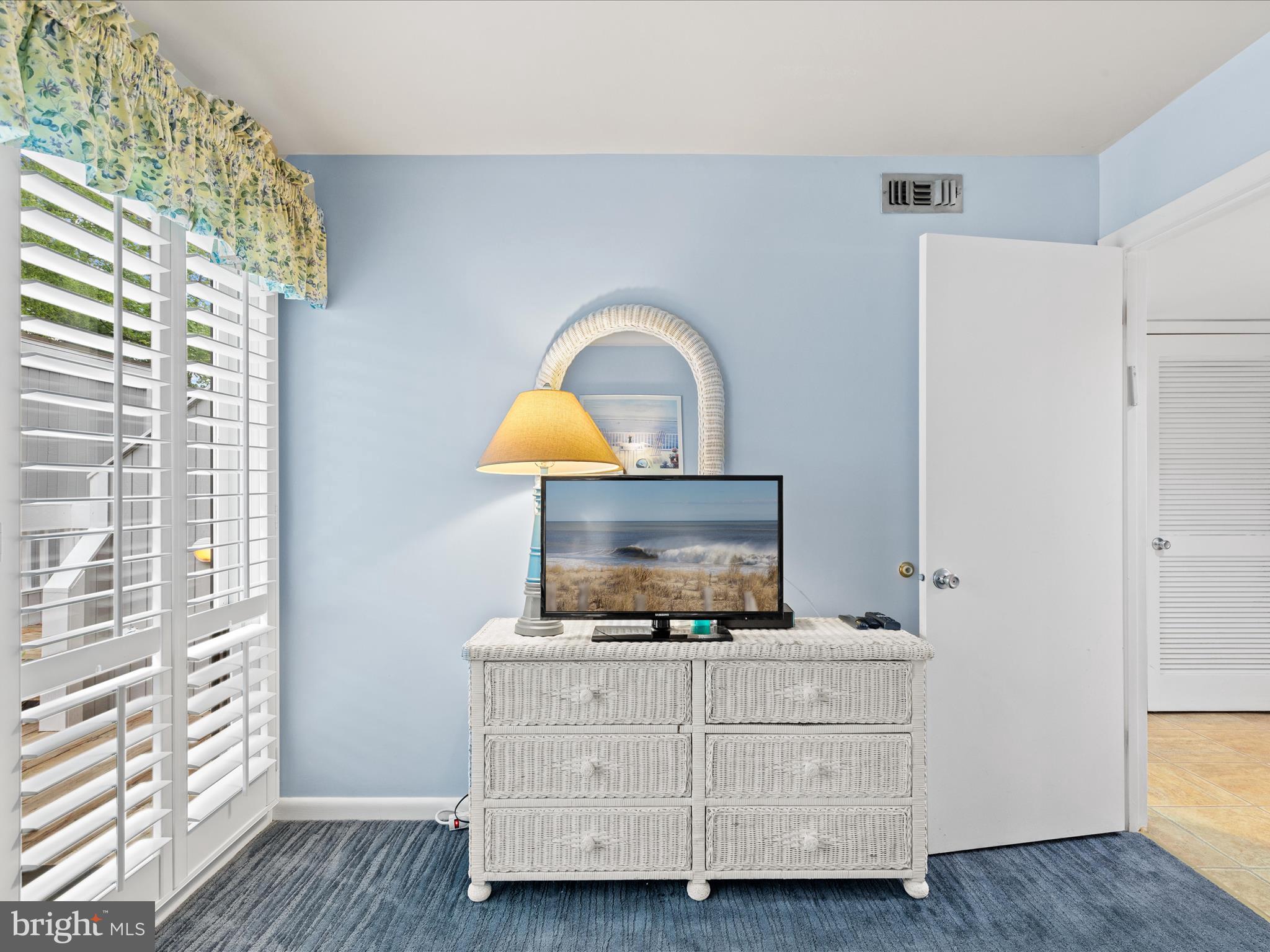 39346 Racquet Lane, Unit 8502 Bethany Beach, DE 19930 - Photo 25 of 33 a living room with furniture and a flat screen tv