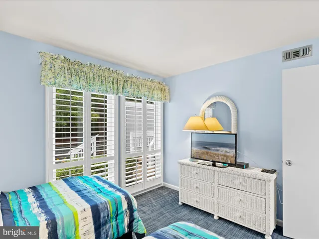 a bedroom with a bed and a television