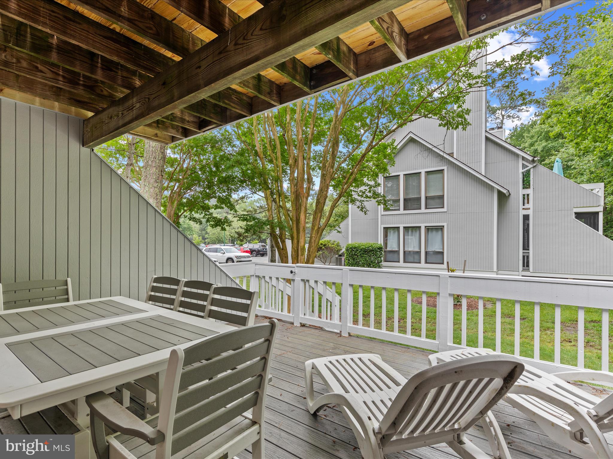 39346 Racquet Lane, Unit 8502 Bethany Beach, DE 19930 - Photo 28 of 33 a view of a patio with a table and chairs