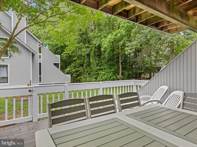 a view of a wooden deck with a bench