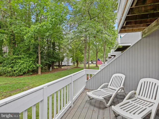 a view of balcony with wooden floor and outdoor seating