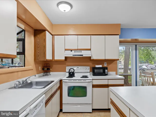 a kitchen with stainless steel appliances a stove a sink and a refrigerator