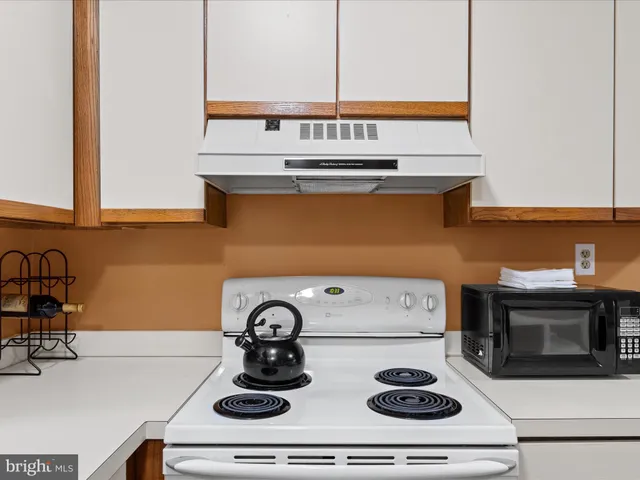 a kitchen with a stove and a microwave