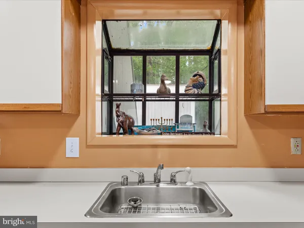 a bathroom with a sink and a window