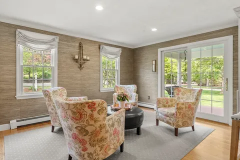a living room with furniture and floor to ceiling windows