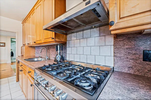 a stove top oven sitting inside of a kitchen